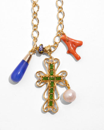 Detail of Katerina Psoma Lucilla necklace — vintage cross pendant with pearl, coral, blue agate and trade bead charms on a brass chain