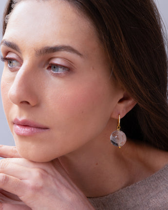 A model wearing the Katerina Psoma Cashmere earrings — hand-carved crystal quartz dragon bead on a pavé gold hook