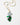 A gold chain necklace featuring a grapevine pendant with green and lavender beads, green enamel leaves, and a faceted iridescent bead at the top, displayed on a clean white background.