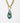 detail of Katerina Psoma Plume Murano chain Pendant made of gold chain necklace with a toggle clasp and a teardrop-shaped pendant featuring a glossy, layered swirl of black, blue, green, and iridescent tones, set against a plain white background.