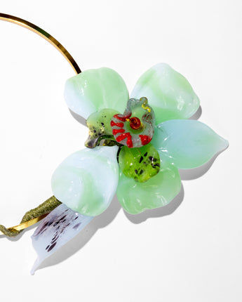 Close up detail of a Katerina Psoma Short gold plated metal necklace with one big Murano glass flower in light green colors