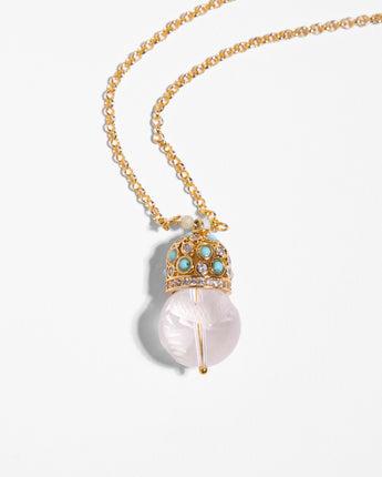 Detail of Katerina Psoma Cupola pendant chain necklace with a carved crystal quartz and gold plated metal dome adorned with turquoise