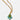 Gold necklace with a green teardrop pendant and turquoise beads on a white background