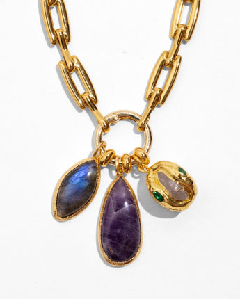 Detail of Katerina Psoma Lucilla necklace — labradorite, amethyst and agate charms with a green crystal accent, on a gold paperclip chain