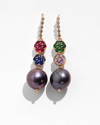 Katerina Psoma Gemma earrings — pavé crystal flower clusters in ruby, sapphire, emerald and amethyst with a grey pearl drop.