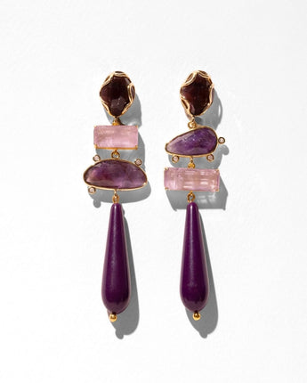 A pair of gold-tone drop earrings featuring stacked purple and pink gemstones, including teardrop-shaped beads and rectangular pink stones, set against a plain white background.
