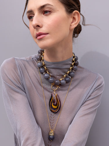 A model wearing necklaces plus Katerina Psoma Cashmere necklace — grey agate beads with vintage agate accents and a pavé gold clasp