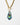 detail of Katerina Psoma Plume Murano chain Pendant made of  gold chain necklace with a toggle clasp and a teardrop-shaped pendant featuring a glossy, layered swirl of black, blue, green, and iridescent tones, set against a plain white background.
