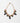 A gold-tone chain necklace with pink and green floral embellishments, featuring faceted green beads, pink enamel leaves, and teardrop-shaped purple and green stones, displayed on a clean white background.