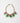 A gold-tone chain necklace featuring a decorative floral centerpiece with pink flowers, green leaves, and dangling white pearl-like accents, shown on a plain light gray background.