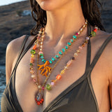 Woman wearing a colorful beaded necklace with a scenic background