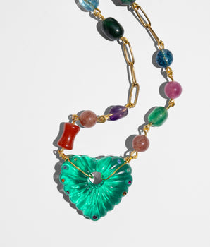 Necklace with colorful beads and a green heart-shaped pendant 