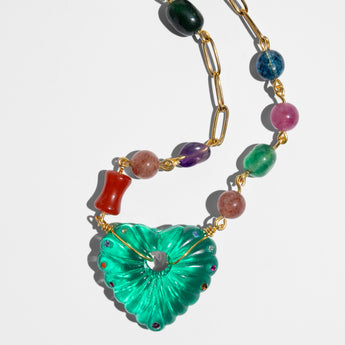 Necklace with colorful beads and a green heart-shaped pendant 