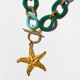 Katerina Psoma Necklace with green and turquoise rope links and a gold starfish charm 