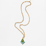 Katerina Psoma Gold necklace with a green teardrop pendant on a white background