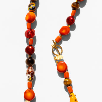 Katerina Psoma Necklace with orange and brown beads on a white background