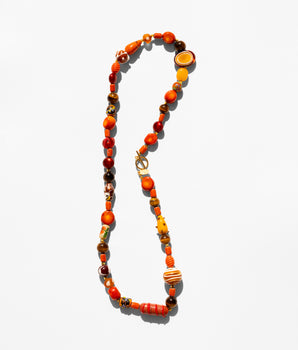 Katerina Psoma Necklace with orange and brown beads on a white background